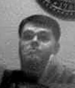 Greyscale photo of Newton looking past a surveillance camera