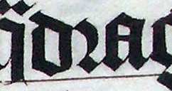 An r rotunda (the middle letter) in the word "quadraginta" in a Latin Bible of 1407, on display in Malmesbury Abbey, Wiltshire, England