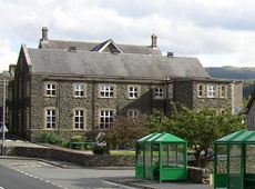 small two-storey building of flint and sandstone