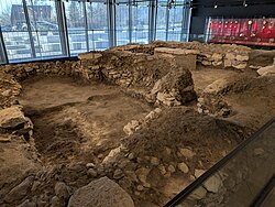 The preserved remains of a church foundation are seen in a museum.