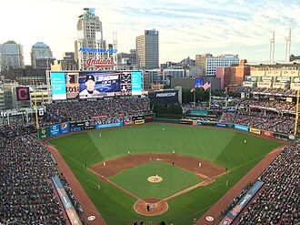 View of a baseball stadium, taken from the upper deck and looking out over the field from center. Open roof