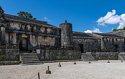 A large and ancient stone mausoleum in an open square