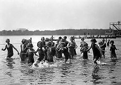 Orphan girls playing in the Tidal Basin in 1924. A float and a diving platform are in the background.