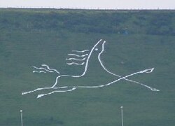 A stylised figure of a galloping white horse. Folkestone White Horse on Cheriton Hill, Folkestone