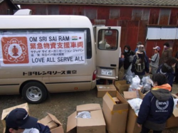 The Sathya Sai Organization's emergency service truck carrying support relief items arriving at the disaster site.