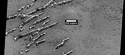 Defrosting dunes and ice in troughs of polygons, as seen by HiRISE under HiWish program