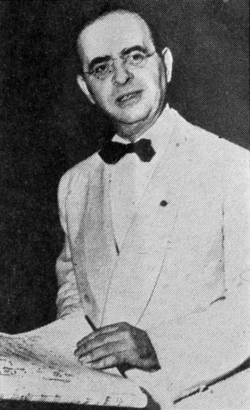 Greyscale photograph of Max Steiner holding music sheets
