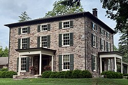 Historic stone house overlooking the river