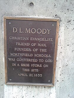 Bronze commemorative plaque mounted on a building wall