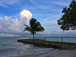 A storm looms off the Corozal coastline opposite the setting sun