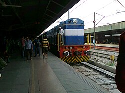 A refurbished locomotive waiting at a junction