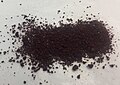 Sample of rhodium(III) chloride.  The compound is so intensely colored that it would be helpful to have an image of a solution (with concentration and solvent specified).