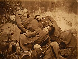 Black and white photograph showing staged scene of dead soldiers from the Paris Commune, 1871
