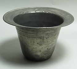 A cylindrical metal container with a brim, much like an upside-down hat