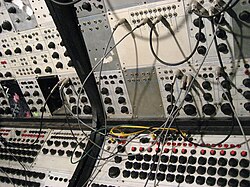 Earliest analog sequencers on Buchla 100 (array of knobs on the bottom)