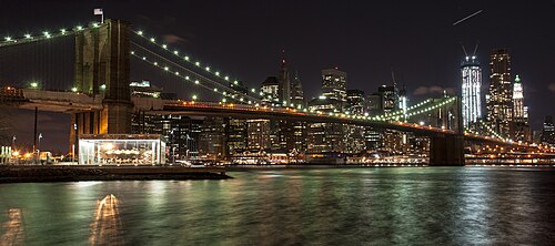 Carousel and Brooklyn Bridge at night