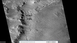 Wide view of part of Milankovic Crater, as seen by HiRISE under HiWish program.  Arrows indicate places where ice is near surface.