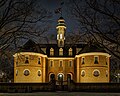 The reconstructed building at night.