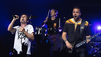 Matt Bellamy, Dominic Howard and Chris Wolstenholme on stage while performing