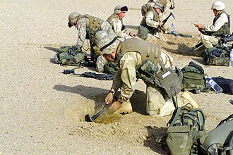 US Marines digging "fighting holes" near the Iraqi border, 2003.