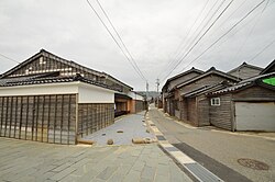 Wooden and black tile-roofed ship-owner houses.