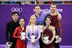 Han Cong, Sui Wenjing, Aljona Savchenko, Bruno Massot, Meagan Duhamel, and Eric Radford pose on the ice
