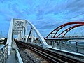 Bình Lợi Railway Bridge next to the same name bridge on Phạm Văn Đồng Boulevard crosses Saigon River in Ho Chi Minh City.