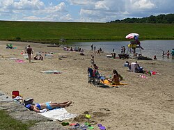 Swimming beach in bathing pond below dam