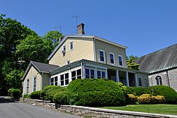 A square two-story yellow house