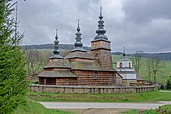 A wooden church with a bell tower