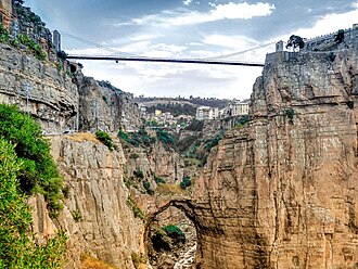=A suspension bridge crossing a deep rocky ravine