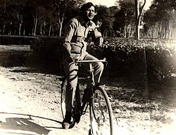 sepia image of Dhiru Bhuyan riding a bicycle