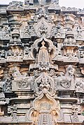 Kirtimukha (demon face) with miniature tower decorative arch combination going up the shrine superstructure