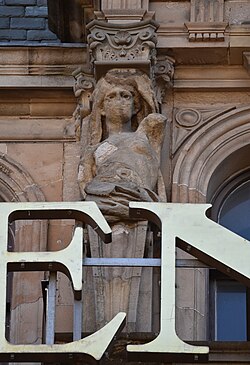 Caryatid (left), pediment over Bay 4, South Saint David Street façade