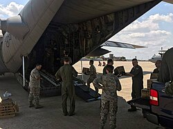 Illinois Air National Guard crew loading supplies aboard a C-130 for Hurricane Harvey relief