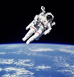 The lower half shows a blue planet with patchy white clouds. The upper half has a man in a white spacesuit and maneuvering unit against a black background.