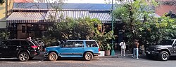 The entry behind multiple parked cars.