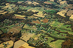 Aerial view of some housing and farmland