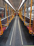 NGR (refurbished) MA Carriage longitudinal seating with priority seats coloured red.