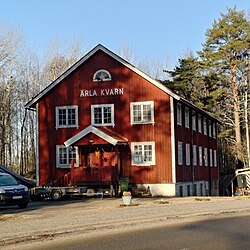 Two story red building with pointed roof