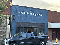 A square blue store with the signage reading "MacLellan Bagpipes" on the front