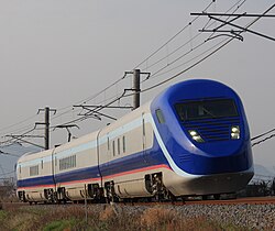 The second-generation "Free Gauge Train" set on a daytime test run on the Yosan Line near Kanonji Station in March 2012