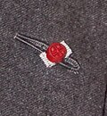 Rosette flanked both sides in silver, denoting the wearer has been awarded the Commander of the Legion of Honour