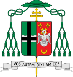 Shield topped by a mitre, featuring a silver field divided per red saltire, four red crosses within the four quarters, and a silver wind mill on the saltire