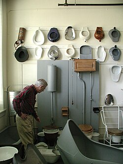 Museum collection of toilets, bed pans, hip baths, etc. The modern toilet commode is on the right.