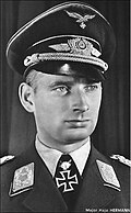 Black-and-white portrait of a man wearing a military uniform with an Iron Cross displayed at his neck.