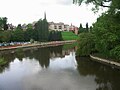 A view from the bridge looking downstream. The Abbey Gardens are on the right.