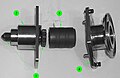 A partially disassembled CBM Powered Bolt, showing both ends of the shaft (1), the lower housing (2) that nestles into the ACBM ring, the drive sleeve (3) and its spline interface with the shaft, and the upper housing (4). The upper housing and drive sleeve can be removed without demating the vestibule to install a spline lock under an IVA seal "butter dish". The spline lock prevents the bolt from backing out.