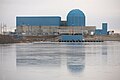 Modern plants have tended towards a design that is not completely cylindrical or spherical, like this containment within the blue painted reactor building of the Clinton Nuclear Generating Station.