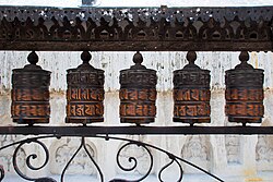 Rolling metal prayer wheels circling the Swayambhunath stupa, Kathmandu